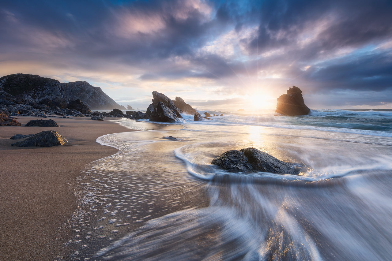 Sunset at Praia da Adraga in Portugal.