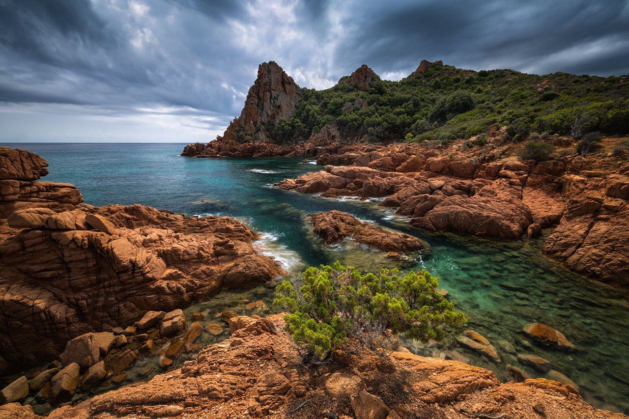 Red rocks, deep blue water, lush vegetation on Italy's costline