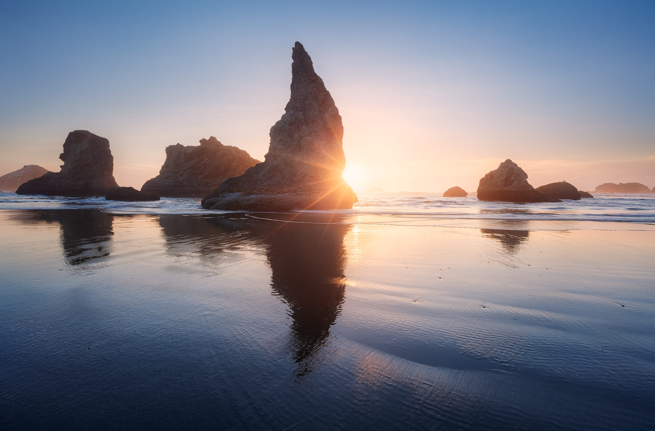 Sunset behind the sea stacks of Bandon Beach in Oregon.