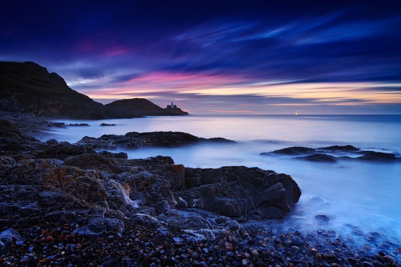 The Mumbles Lighthouse and Bracelet Bay on the Gower Peninsula in Wales.